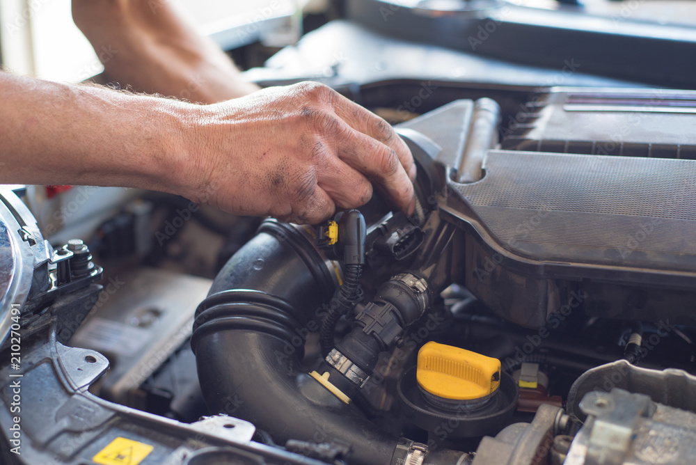 Auto mechanic repairing car. Selective focus. Auto mechanic repairing car. Selective focus.