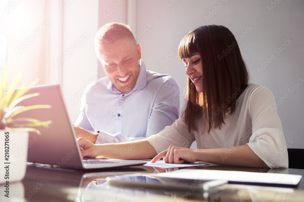 Two Businesspeople Working On Document Two Businesspeople Working On Document