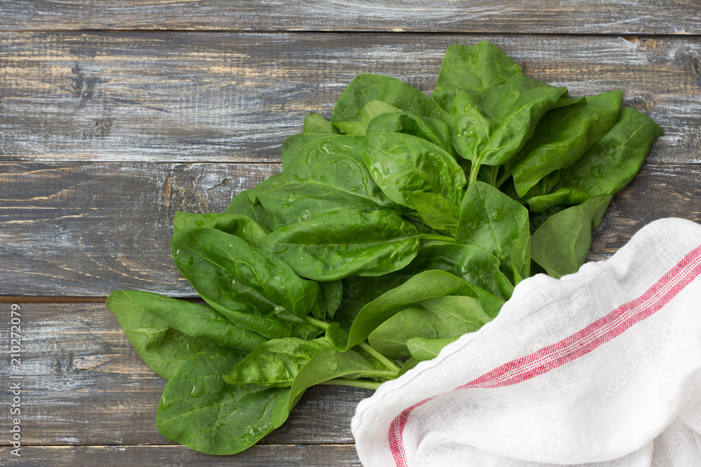 Bunch of fresh spinach with roots on a cutting board with a knife. on a wooden table. rustic style. free space Bunch of fresh spinach with roots on a cutting board with a knife. on a wooden table. rustic style. free space