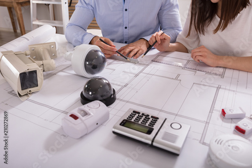 Obraz na płótnie Two Architects Planning Project On Blueprint