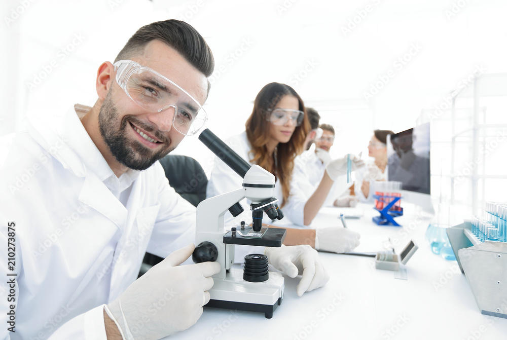 closeup of male technician sitting at his working in the laboratory closeup of male technician sitting at his working in the laboratory