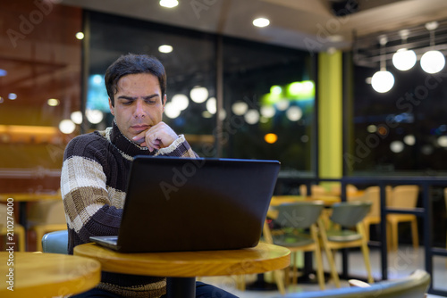 Man using laptop computer while thinking