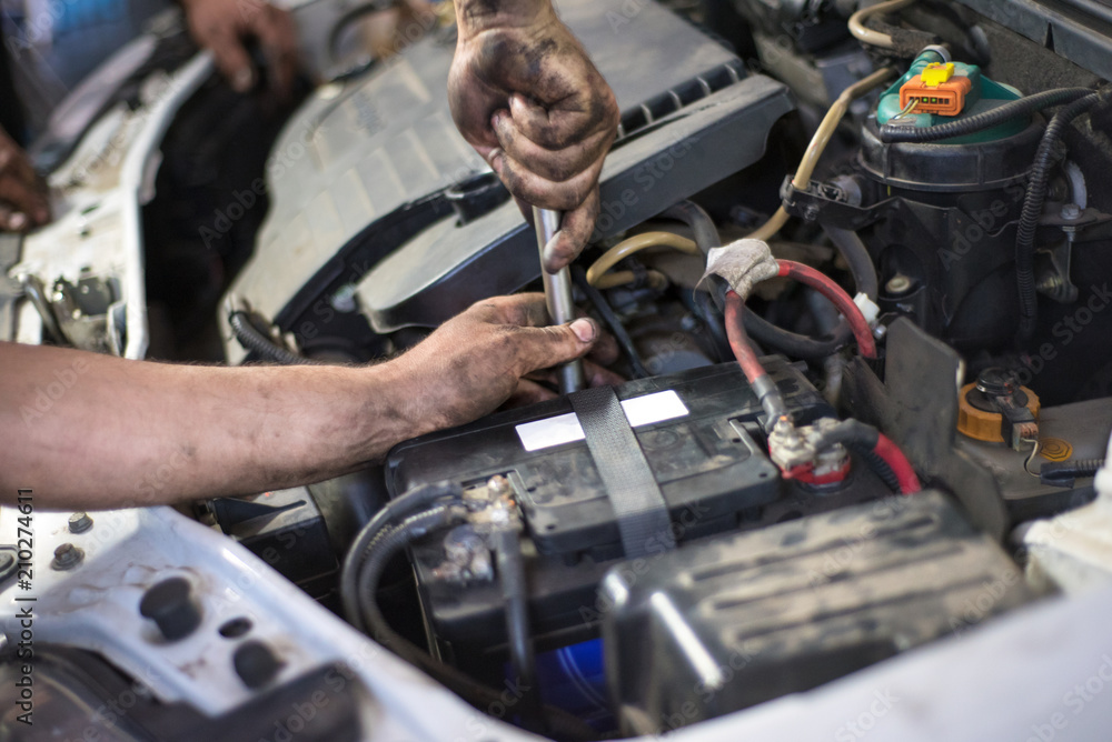 Auto mechanic repairing car. Selective focus. Auto mechanic repairing car. Selective focus.