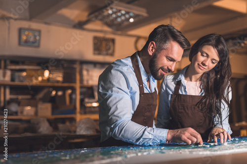 Smiling people in aprons at work