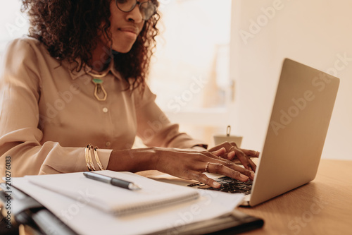 Woman entrepreneur working from home on laptop photo