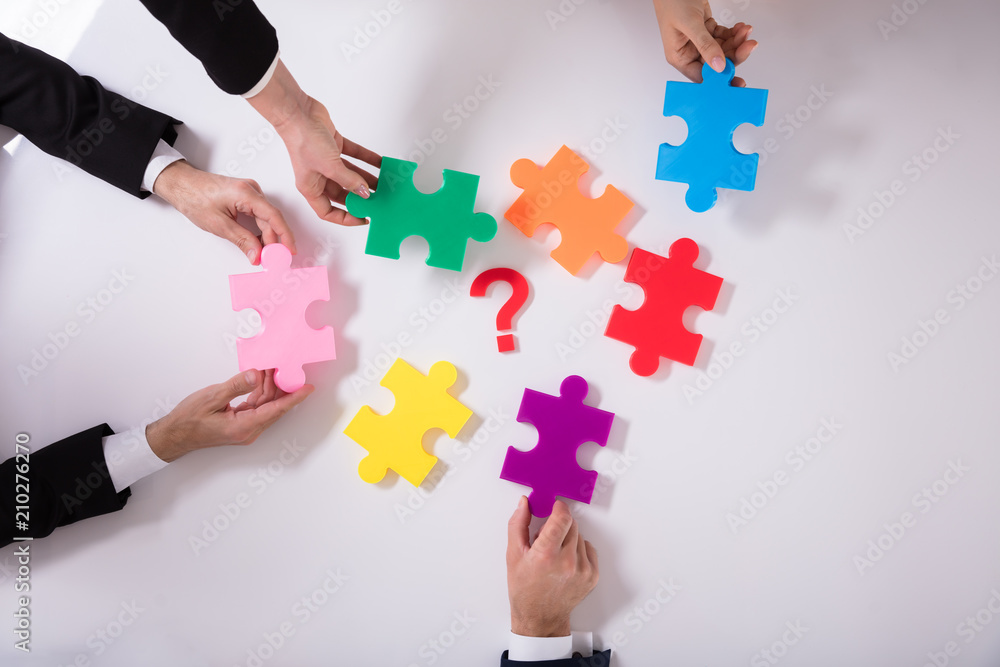 Group Of Businesspeople Holding Jigsaw Puzzle Group Of Businesspeople Holding Jigsaw Puzzle