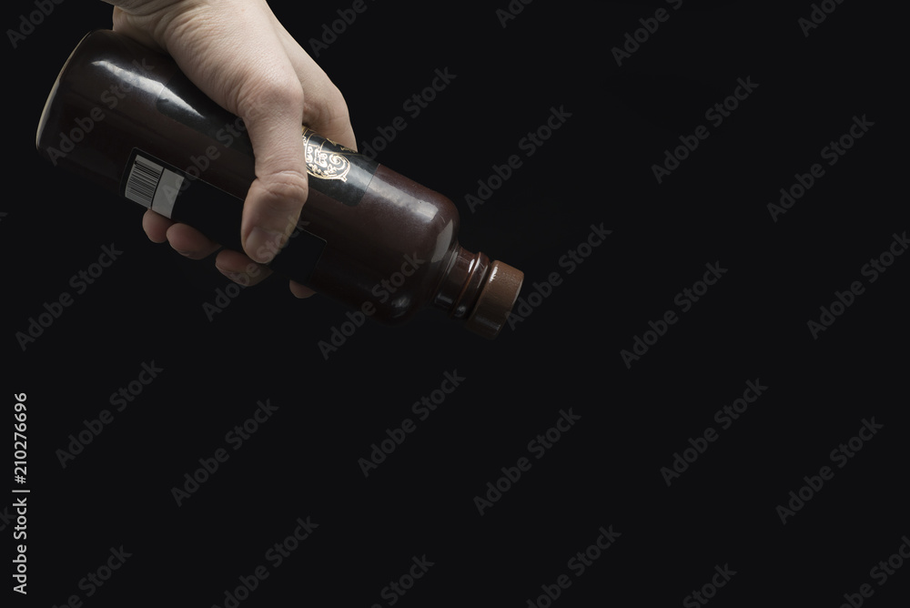 hand holding a bottle hand holding a bottle