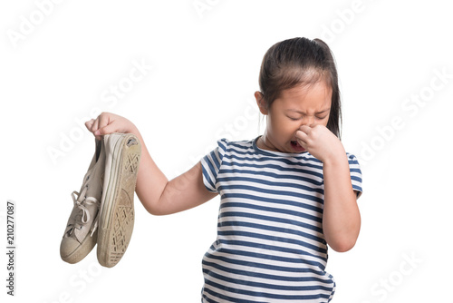 Asian kid girl age 7 year hold stinky shoe on white background