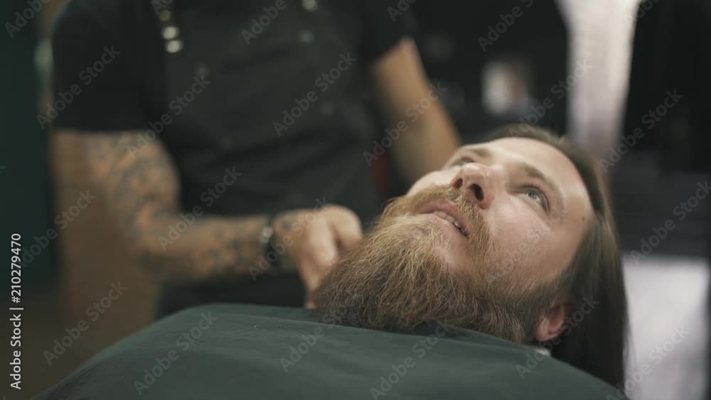 Barbershop, hairdresser cuts a men beard.
Barbershop, hairdresser cuts a men beard.