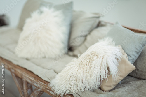A self-made sofa with light soft pillows in a light-white interior