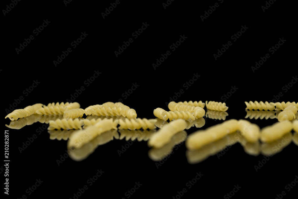 Fototapeta premium Pasta on a black background that spells pasta time, closeup