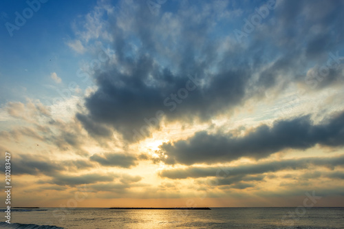 Beautiful early morning sunrise over the sea the horizon,blue sky background texture with white clouds sunset. © Thinapob