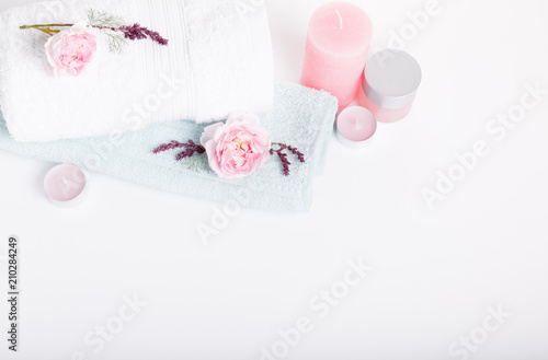 Spa concept in Valentine's Day, Birthday Day, pink roses, candles, blue towels, flowers. Spring or summer background