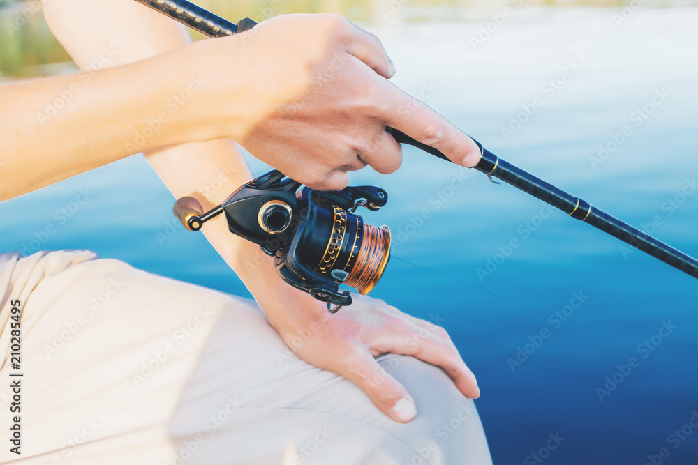 Fishing. A man in his hands holds a reel Fishing. A man in his hands holds a reel
