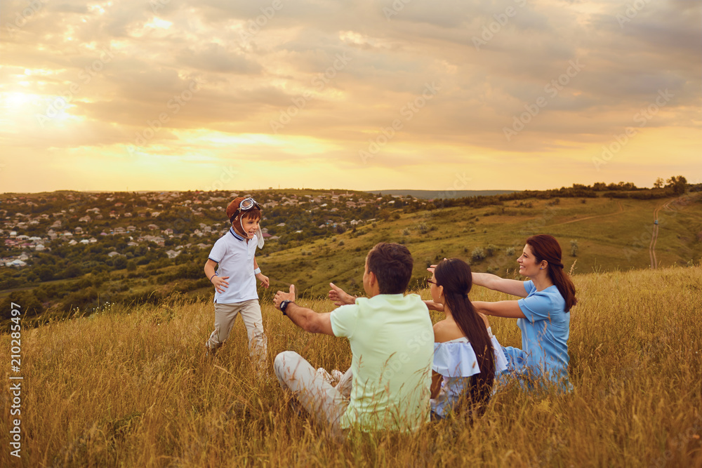 Happy family having fun playing on grass in nature at sunset. Happy family having fun playing on grass in nature at sunset.