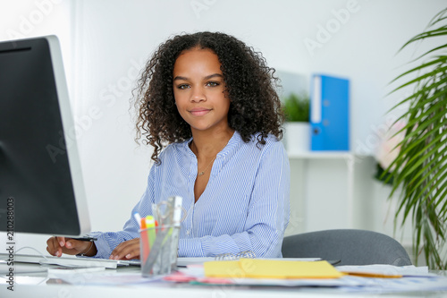 Metisse secretary working in office