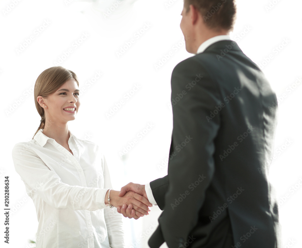 handshake young business woman with a colleague