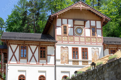 A beautifully renovated building with wooden decorations and paintings on Dietla Square in the health resort Szczawnica Zdrój