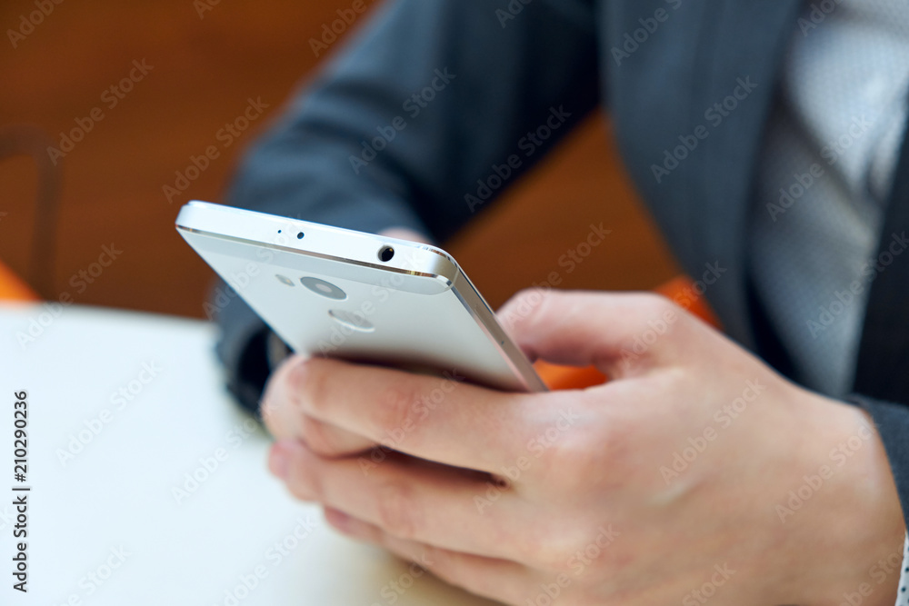 Woman business holding smart phone with blurred background. Woman business holding smart phone with blurred background.