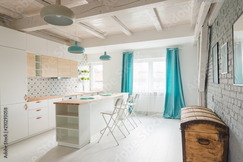 Open bright kitchen with white furniture. Island kitchen. © Daniel Jędzura