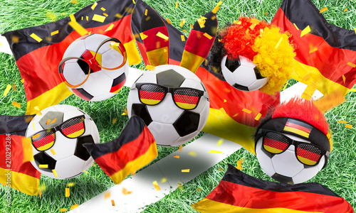   German soccer fans cheer on the field with fan articles and confetti photo