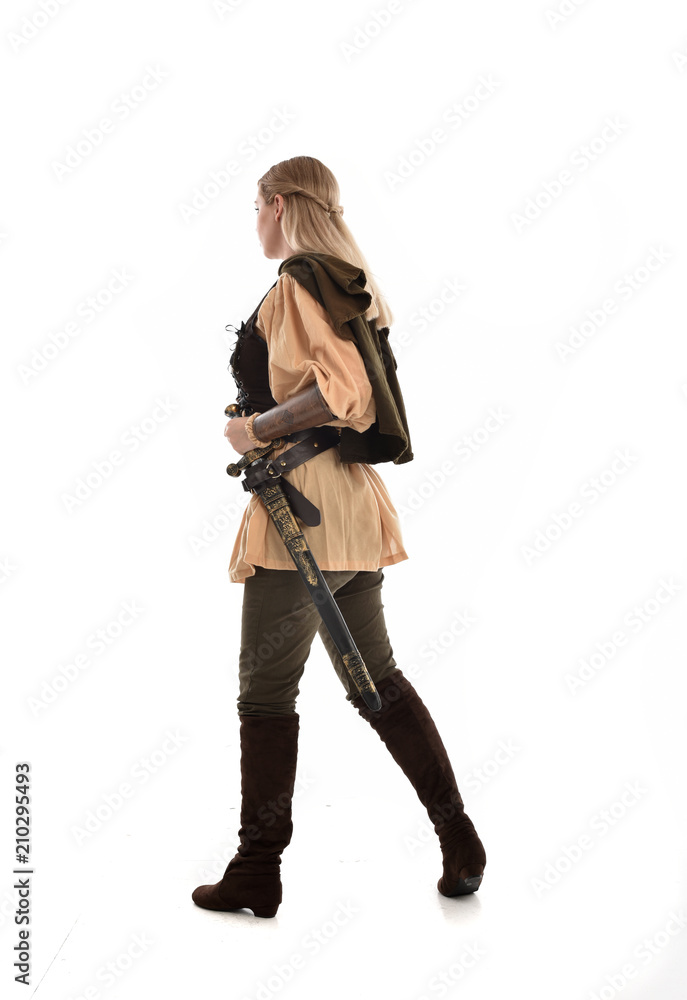 full length portrait of girl wearing medieval costume with sword. standing pose with back to the camera, isolated on white studio background. full length portrait of girl wearing medieval costume with sword. standing pose with back to the camera, isolated on white studio background.