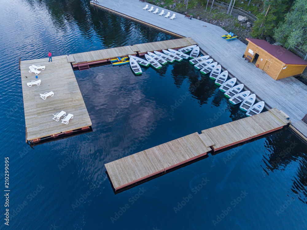 Aerial view of a man who swims on a lake on a pedal catamaran, a water bike Aerial view of a man who swims on a lake on a pedal catamaran, a water bike