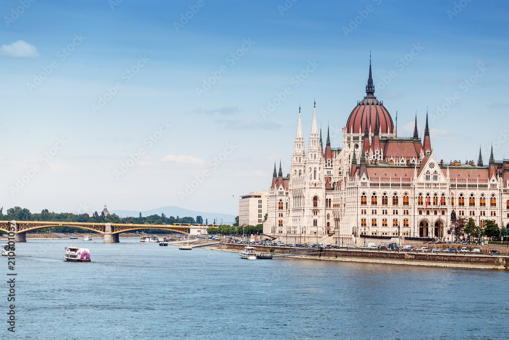 a classic view of the famous tourist attraction of Budapest - the Hungarian Parliament and the Danube River with ships