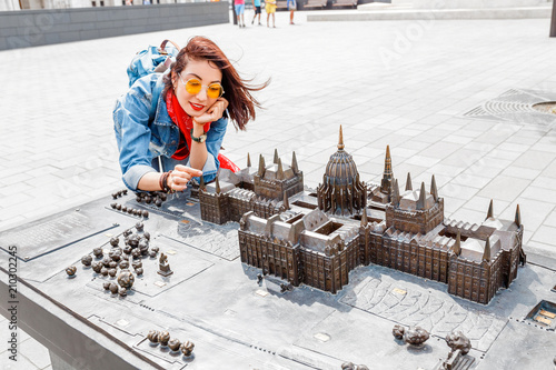 Traveler woman looking at Miniature model of Hungarian Parliament in mini park in Budapest photo