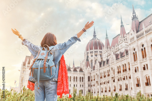 Happy asian casual woman student enjoying great view of the Parliament building in Budapest city, travel in Europe concept