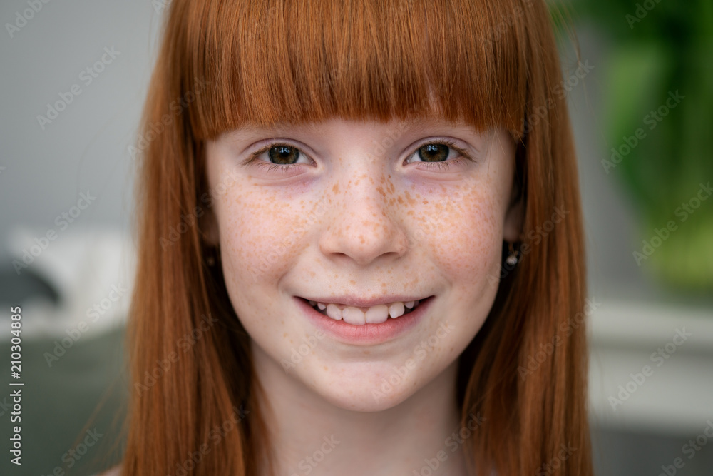 Happy little ginger girl with freckles smiling Happy little ginger girl with freckles smiling