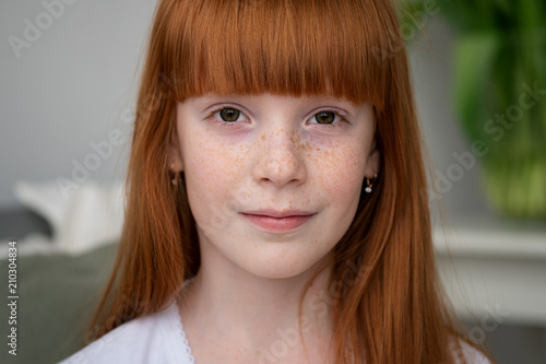 Little happy ginger girl with freckles