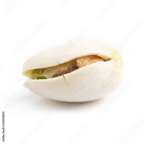 few ripe roasted pistachios isolated on white background