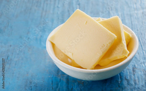 Sliced slabs of fresh butter in a small dish