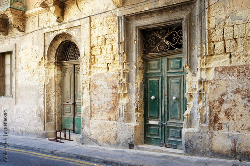 Fototapeta Naklejka Na Ścianę i Meble -  Colorful street in the City of Sliema, Malta. Doorway To Maltese House.