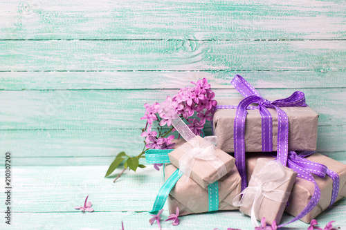 Boxes with presents and fresh lilac flowers