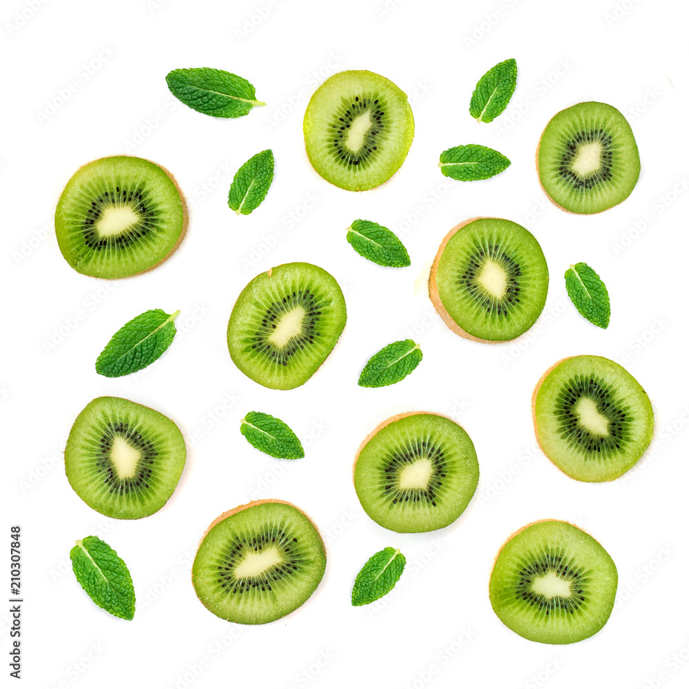 Fruit Pattern - Creative layout made of Kiwi fruits and mint leaf. Many slices of ripe Kiwifruit..Flat lay. Fruit Pattern - Creative layout made of Kiwi fruits and mint leaf. Many slices of ripe Kiwifruit..Flat lay.