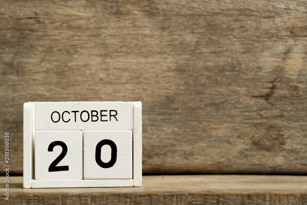 White block calendar present date 20 and month October on wood background White block calendar present date 20 and month October on wood background