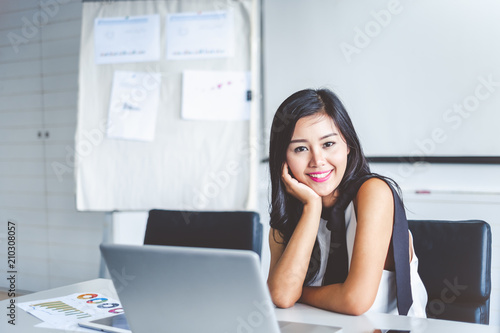 Portrait young asian businesswoman working on laptop at office during  smiling and happy working.