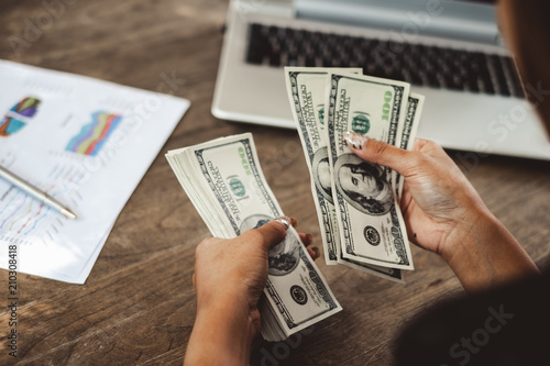 Woman accountant counting money dollars banknote, business financial concept photo