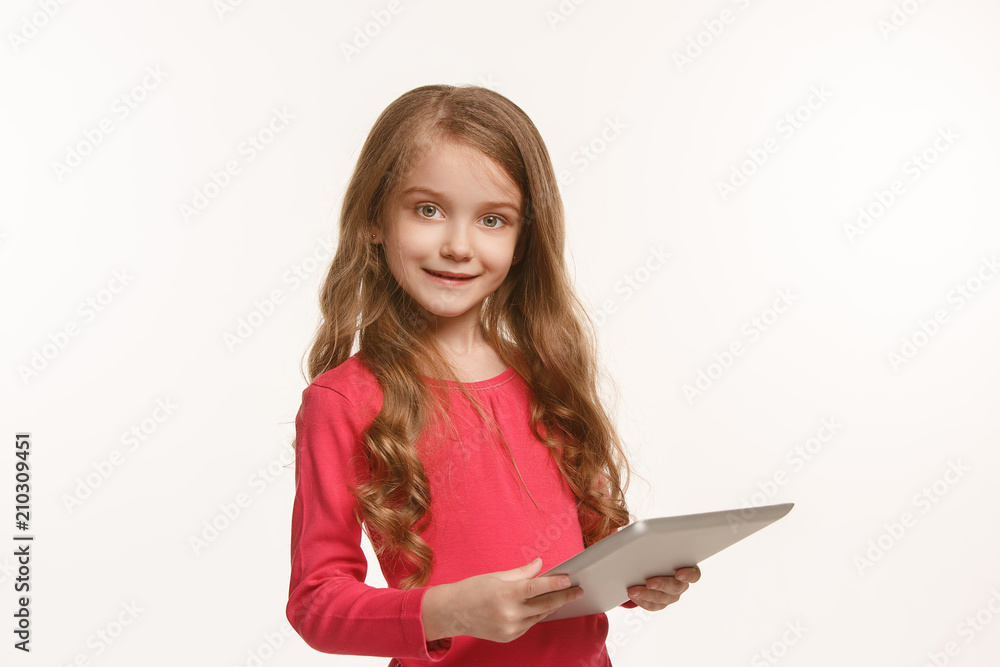 Little funny girl with tablet on green background Little funny girl with tablet on green background