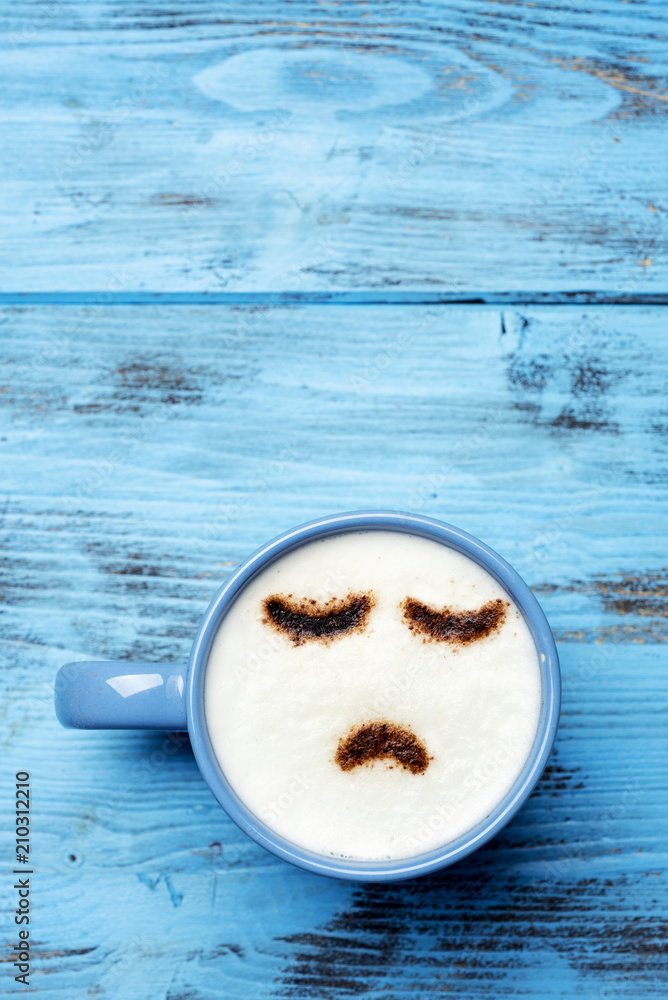 cup of cappuccino with a sad face - obrazy, fototapety, plakaty 