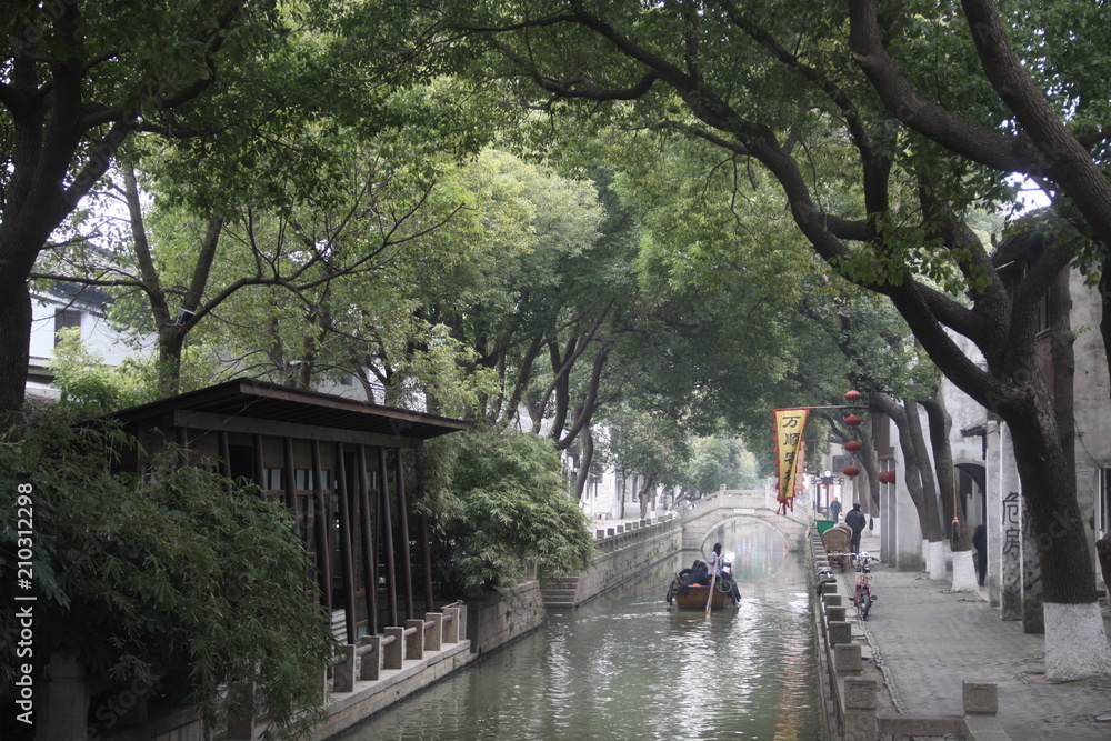 very nice Chinese houses next to canal surrounded with trees very nice Chinese houses next to canal surrounded with trees