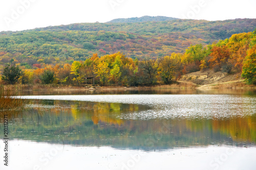 Autumnal landscape with lake and hills
