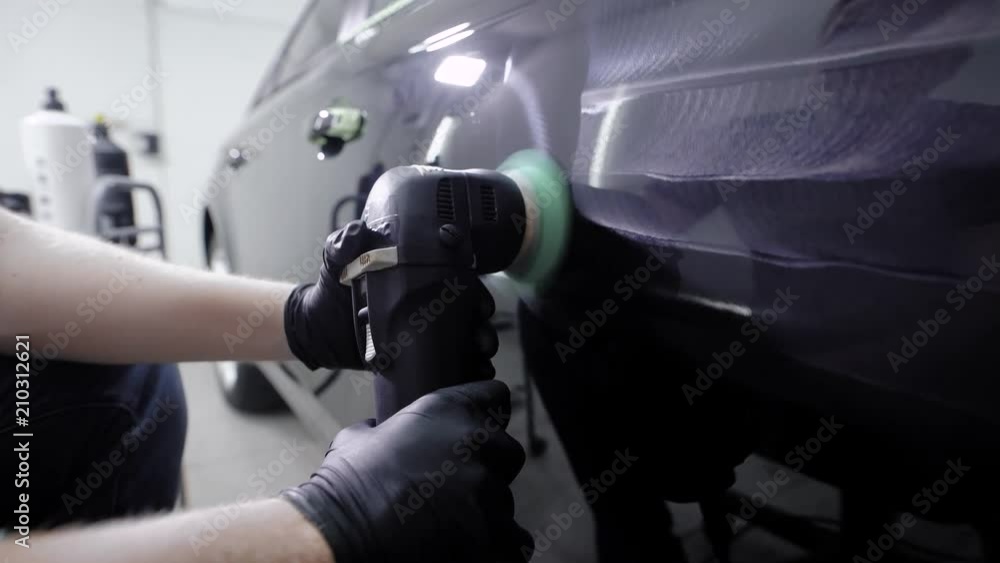 master is processing surface of car body by polishing machine, applying protective composition in a garage master is processing surface of car body by polishing machine, applying protective composition in a garage