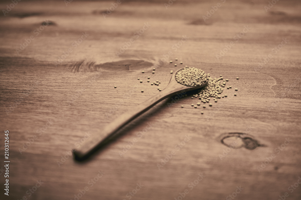 spoon with quinoa on table spoon with quinoa on table