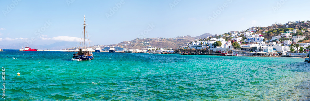 Panoramic view of Greek seaside town and floating ships in water