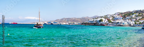 Panoramic view of Greek seaside town and floating ships in water