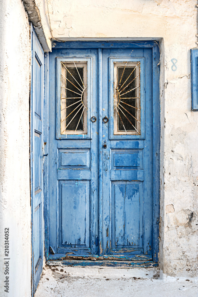 Vintage blue wooden door with cracked paint