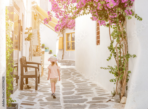Little girl walking the narrow alley in Greece © tan4ikk